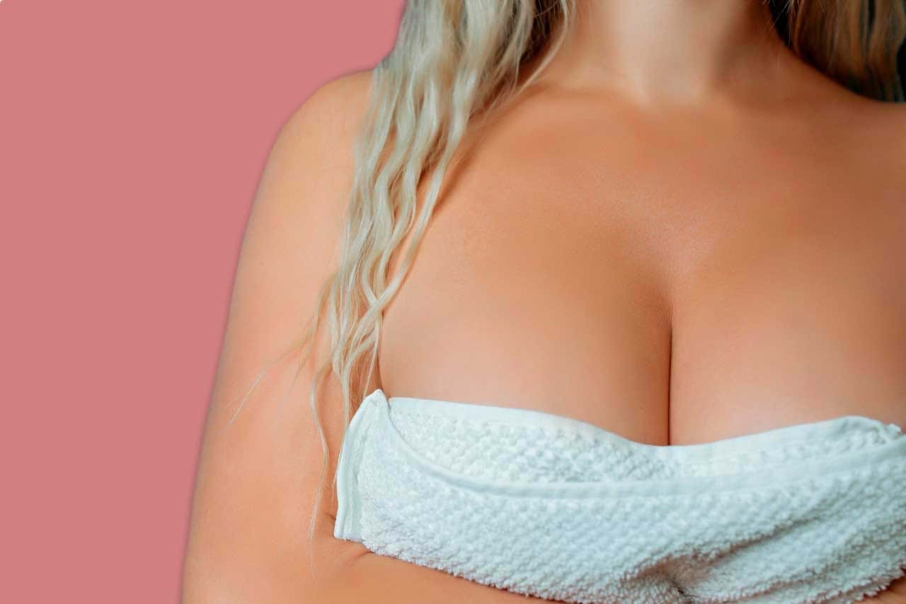 woman after breast augmentation with towel